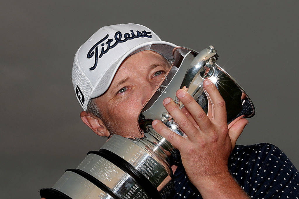 Matt Jones kisses the Australian Open trophy